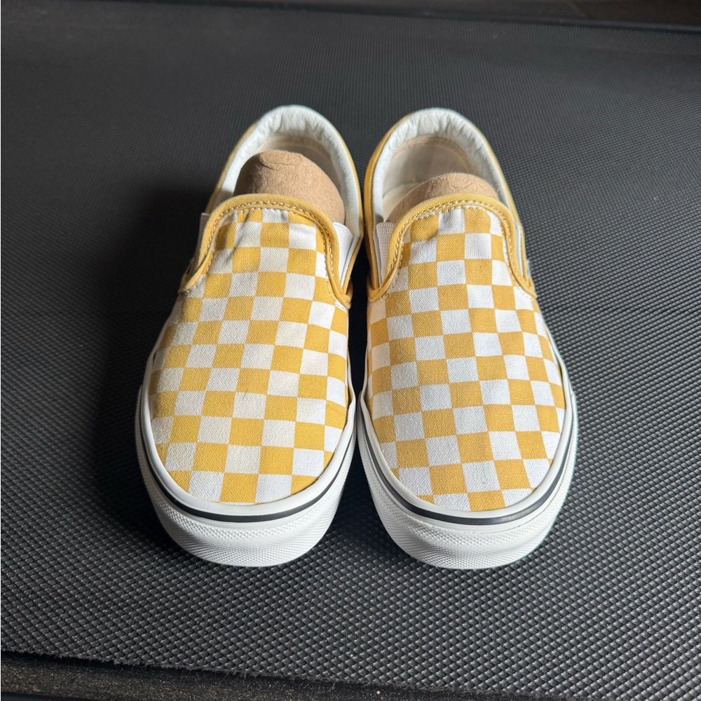 Yellow and white slip on vans